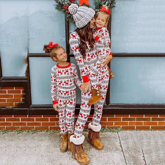 Mother and two daughters in matching red and white reindeer and snowflake print long-sleeve Christmas pajamas. - Image 26