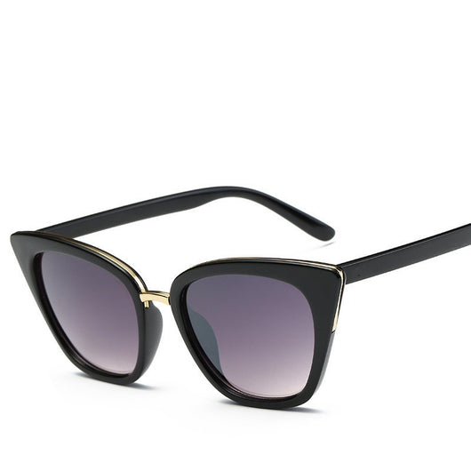 Black cat-eye sunglasses for women with gradient grey lenses and subtle gold-tone metal accents on the frame. - Image 7