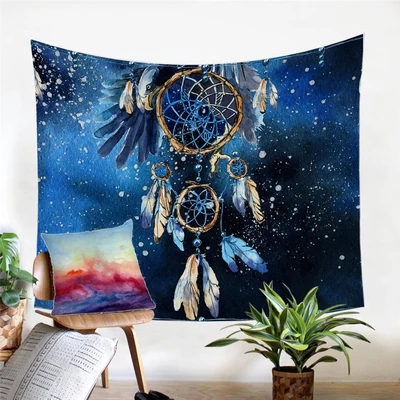 Blue watercolor dreamcatcher tapestry with feathers and beads, hanging on a white wall in a cozy room.