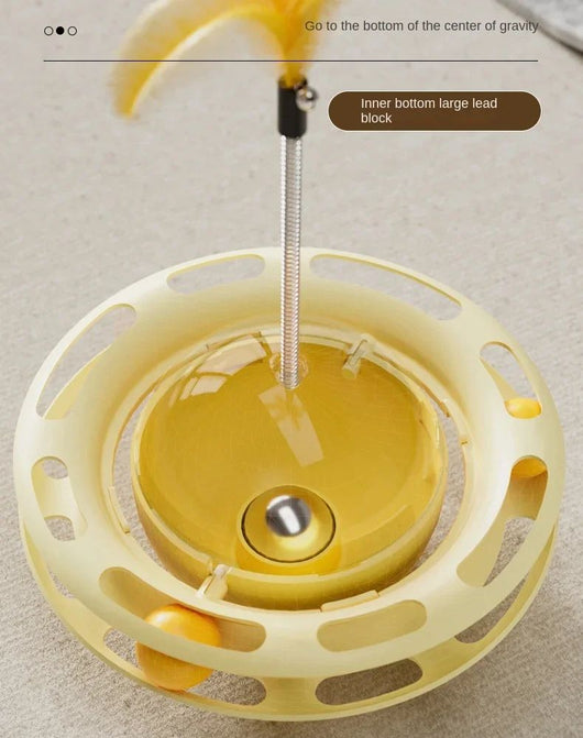 Yellow UFO tumbler cat toy with rolling balls, a clear dome, and a spring-mounted feather wand with a bell. - Image 9