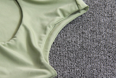 Light green two-piece set featuring a sleeveless crop top with a high neck and chest cutout, paired with a ruched bodycon mini skirt. - Image 24