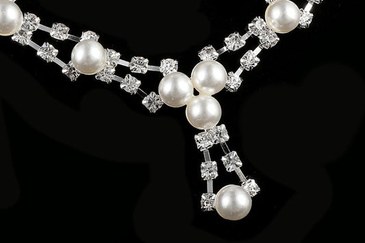 Silver-tone bridal jewelry set with a pearl and rhinestone necklace and matching dangle earrings. - Image 2