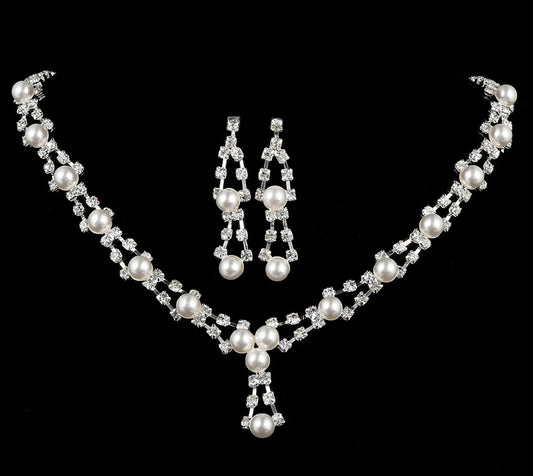 Silver-tone bridal jewelry set with a pearl and rhinestone necklace and matching dangle earrings.