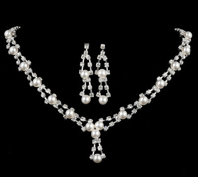Silver-tone bridal jewelry set with a pearl and rhinestone necklace and matching dangle earrings.