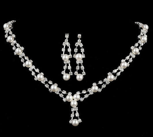Silver-tone bridal jewelry set with a pearl and rhinestone necklace and matching dangle earrings.