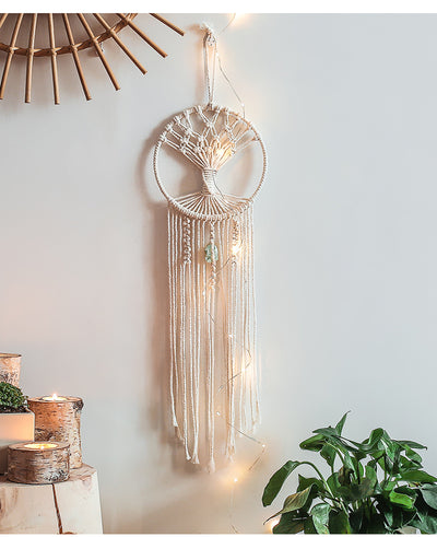 Handmade macrame dream catcher with a tree of life design, natural cotton rope, and a light green stone accent.