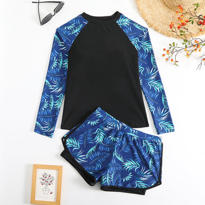 Women's long-sleeve tankini swimsuit with black top and blue tropical leaf print raglan sleeves, matching swim shorts. - Image 3