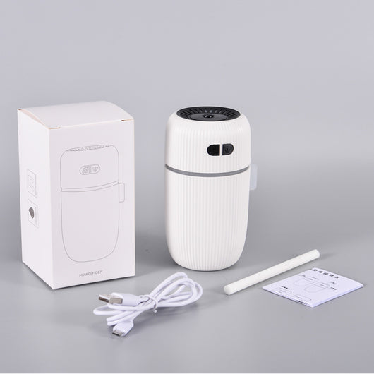 Black ribbed white noise humidifier with control buttons on top, designed to aid sleep and humidify. - Image 2