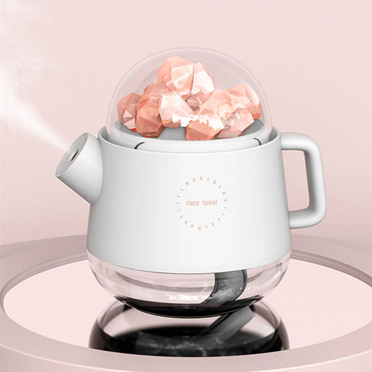 Pink kettle-shaped mini USB humidifier with a clear dome top filled with pink salt crystals, emitting mist. - Image 10