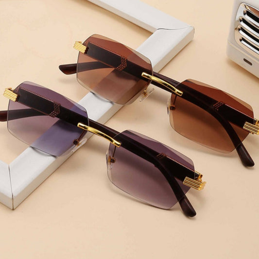 Frameless sunglasses with pink gradient lenses and dark brown wood-look temples with gold-tone accents.