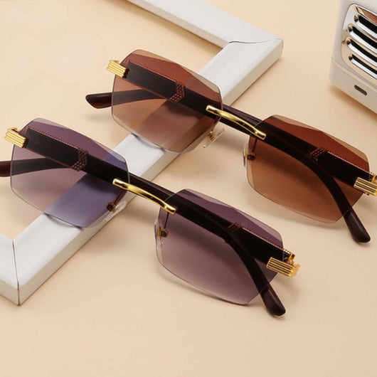 Frameless sunglasses with pink gradient lenses and dark brown wood-look temples with gold-tone accents.
