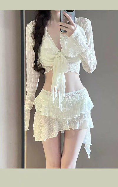 White four-piece bikini swimsuit set for women, featuring a long-sleeve tie-front top and tiered ruffle skirt. - Image 12
