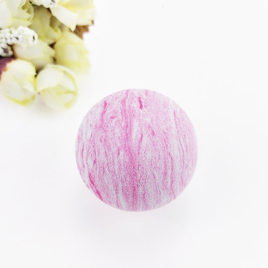 Black and white marbled EVA foam ball, a pet toy, on a white background with blurred flowers. - Image 4