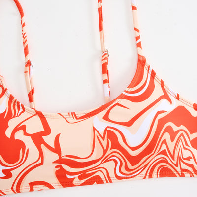 Red, orange, and white abstract swirl print three-piece bikini set with matching shorts, shown with a straw hat and sunglasses. - Image 21