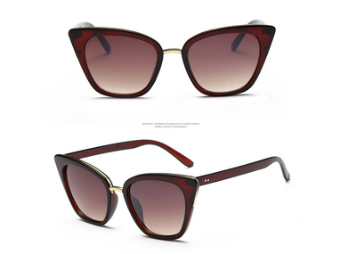 Black cat-eye sunglasses for women with gradient grey lenses and subtle gold-tone metal accents on the frame. - Image 9