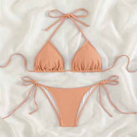 Neon yellow halter bikini with triangle top and tie-side bottoms, displayed on a light wood surface. - Image 32