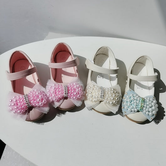Beige girls' princess shoes with pearl and rhinestone bows, featuring a flat heel and a convenient Velcro strap. - Image 4