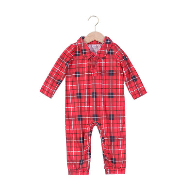 Family of four and their dog wearing matching red and black plaid Christmas pajamas, smiling against a white background. - Image 9