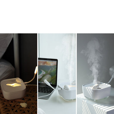 White ultrasonic humidifier with a clear base and a cute polar bear figurine on top, emitting a fine mist. - Image 5