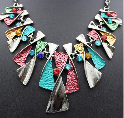 Silver and blue abstract fashion necklace and matching stud earrings set with blue rhinestones on a black mannequin. - Image 5
