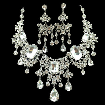 Sparkling rhinestone and crystal bridal jewelry set with a statement necklace and matching chandelier earrings.