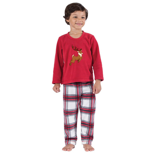 Family of five and a dog wearing matching red long-sleeve reindeer print tops and red and white plaid pajama pants. - Image 11