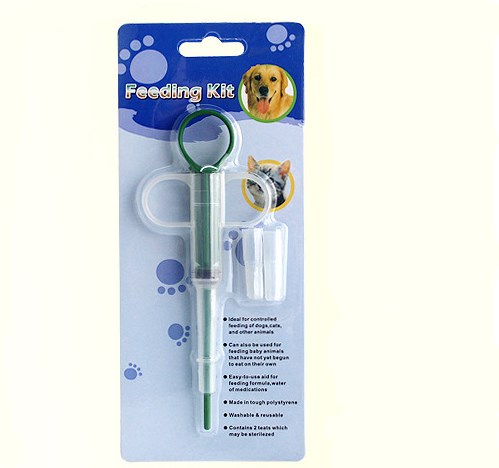 Pet feeding kit with a green syringe-style feeder and two clear teats, packaged for dogs and cats. - Image 4