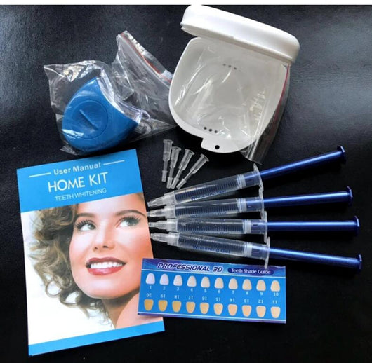 Teeth whitening kit with a blue LED light mouthpiece and a syringe of whitening gel on a white background. - Image 10