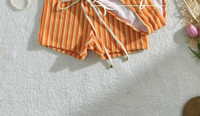 Orange and light orange striped bikini bottom with a ribbed texture and elastic waistband, ideal for beach vacations. - Image 16