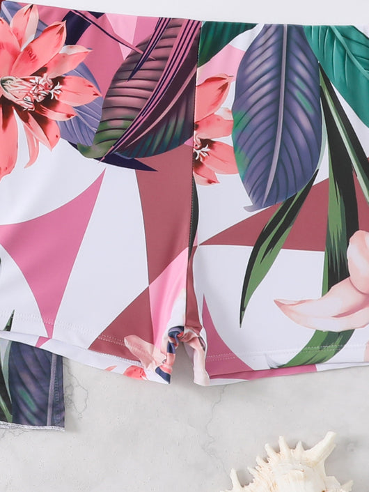 Woman in a three-piece bikini swimsuit set with a black tube top, floral boy shorts, and a sheer floral kimono cover-up. - Image 21