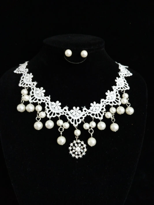 White lace and pearl necklace set with matching stud earrings, featuring a snowflake pendant, on a black display. - Image 2