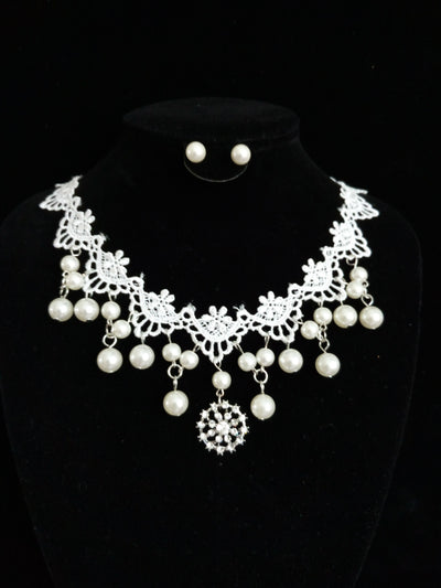 White lace and pearl necklace set with matching stud earrings, featuring a snowflake pendant, on a black display. - Image 2