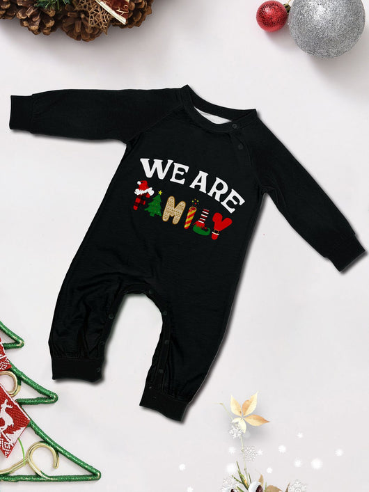 Family of four wearing matching black long-sleeve pajamas with "WE ARE FAMILY" text and black and white plaid bottoms. - Image 19