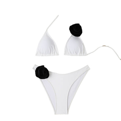Woman wearing a white triangle bikini with a large 3D flower on the top and a smaller one on the bottom. - Image 5