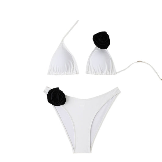 Woman wearing a white triangle bikini with a large 3D flower on the top and a smaller one on the bottom. - Image 5