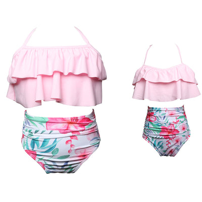 Black wrap bikini top with high-waisted pink and green tropical leaf print swim bottoms. - Image 8