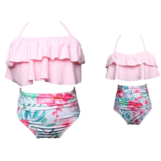 Black wrap bikini top with high-waisted pink and green tropical leaf print swim bottoms. - Image 8
