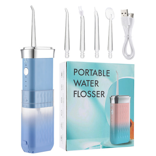 Portable water flosser in gradient pink and blue with four nozzles, a charging cable, and its product box. - Image 6