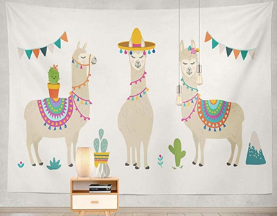 White tapestry featuring three cartoon llamas with colorful saddles, a sombrero, flowers, cacti, and mountains.