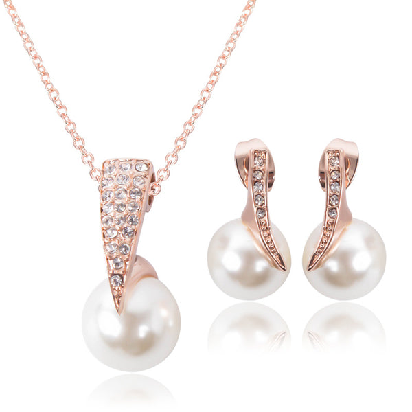Rose gold-toned necklace and drop earrings set with white spherical pearls and clear rhinestone accents.
