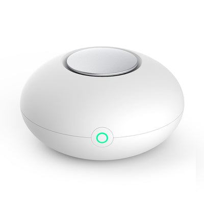 White mini ozone generator and air purifier with a round, compact design and a green indicator light. - Image 10