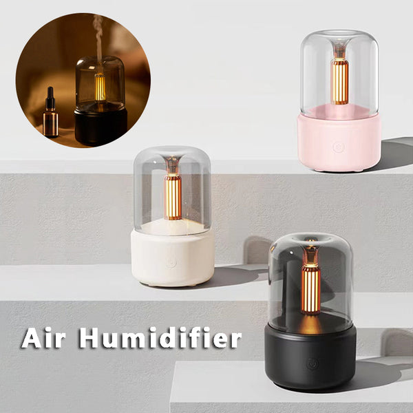 White cylindrical aroma diffuser with a clear top and an amber candlelight-effect LED light.