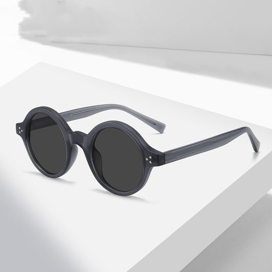 European and American vintage round frame polarized sunglasses with a sand transparent TR90 CAP frame and black and grey lenses.