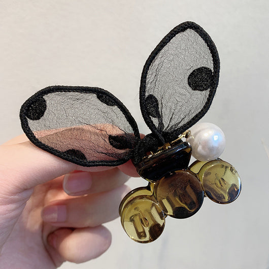 Black sheer polka dot rabbit ears hair claw clip with a faux pearl and gold-toned metal accents.