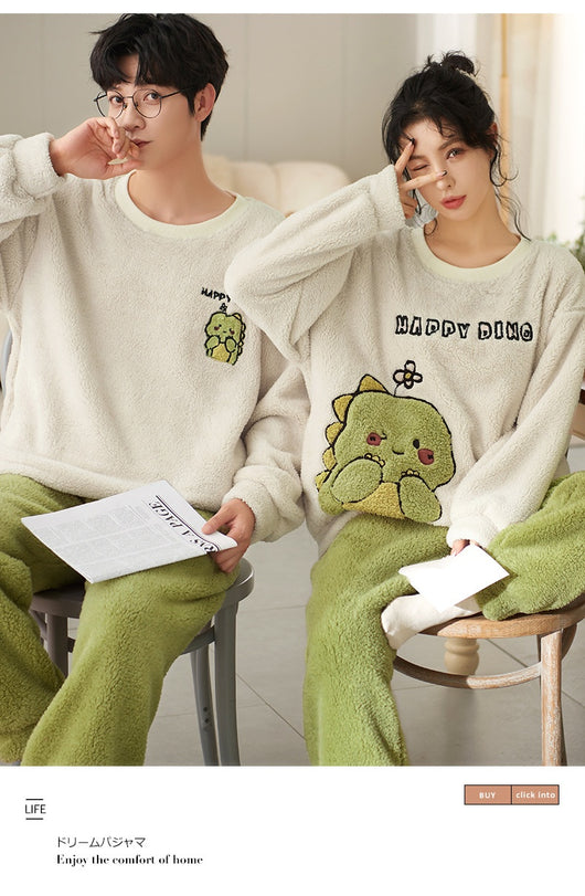 Couple wearing matching cream coral fleece pajamas with gray pants and bear embroidery, seated on a bed. - Image 33