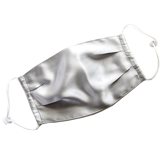 Light pink double layer silk face mask with adjustable white ear loops on an open magazine. - Image 11