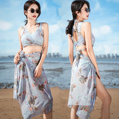 Women's light blue tropical leaf print three-piece swimsuit with short sleeve bikini top, bottoms, and sarong skirt. - Image 7
