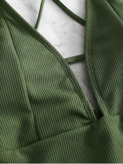 Olive green ribbed one-piece swimsuit with deep V-neck and criss-cross back straps, laid flat on marble. - Image 17
