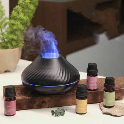Black flame aromatherapy diffuser with purple mist and four essential oil bottles: Lily, Rose, Sakura, and Lemon. - Image 9