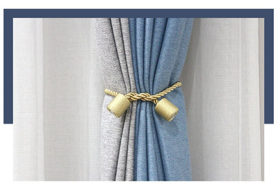 Black cylindrical magnetic curtain tieback holding a light blue pleated curtain, against a clean white background. - Image 11